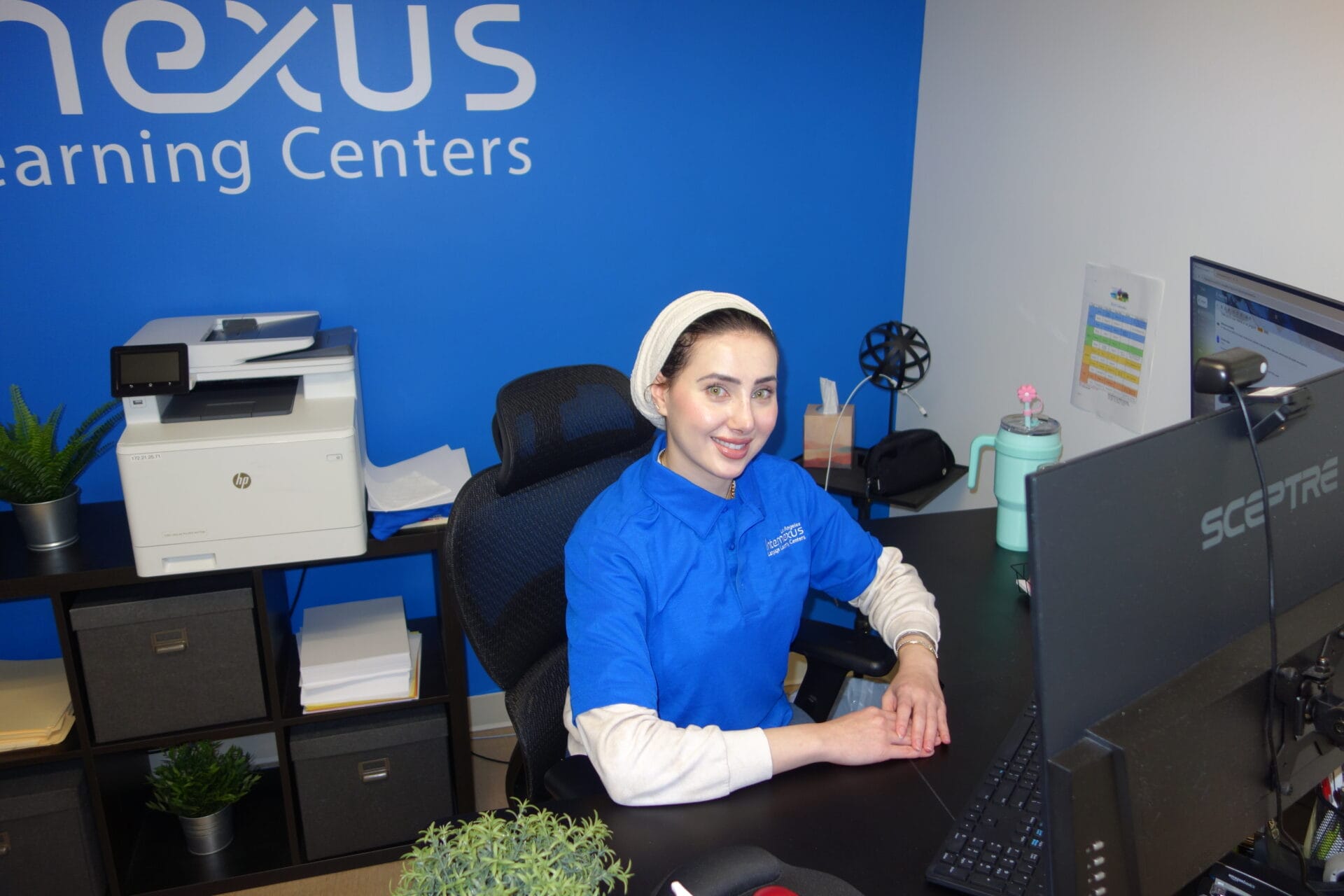 Our program coordinator sits at her desk ready to welcome students.